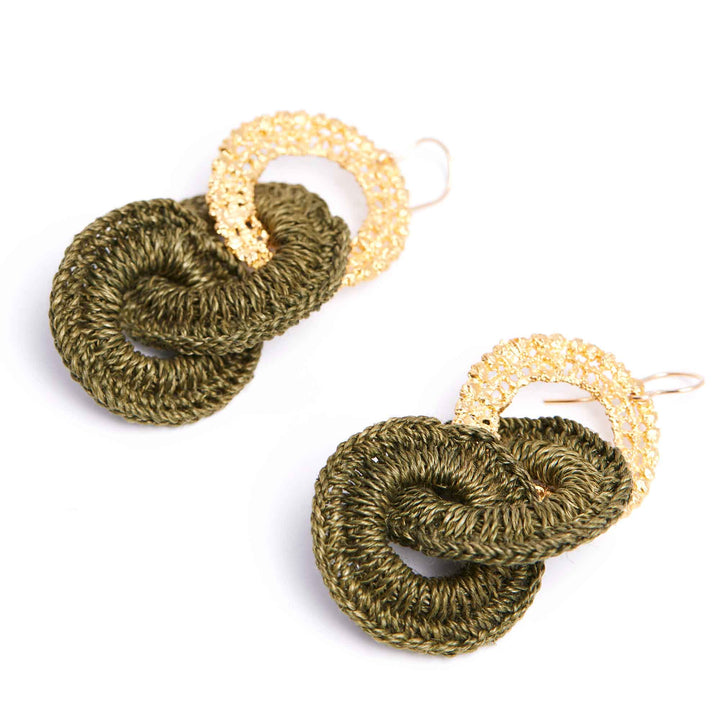 Pair of green and gold crocheted earrings on a white background