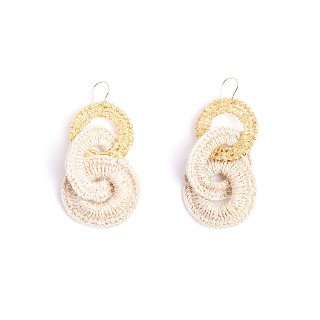 Pair of crocheted earrings with gold and beige loops on a white background