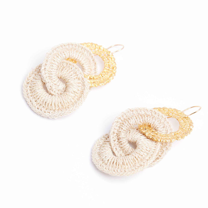 Crocheted earrings with gold loops on a white background