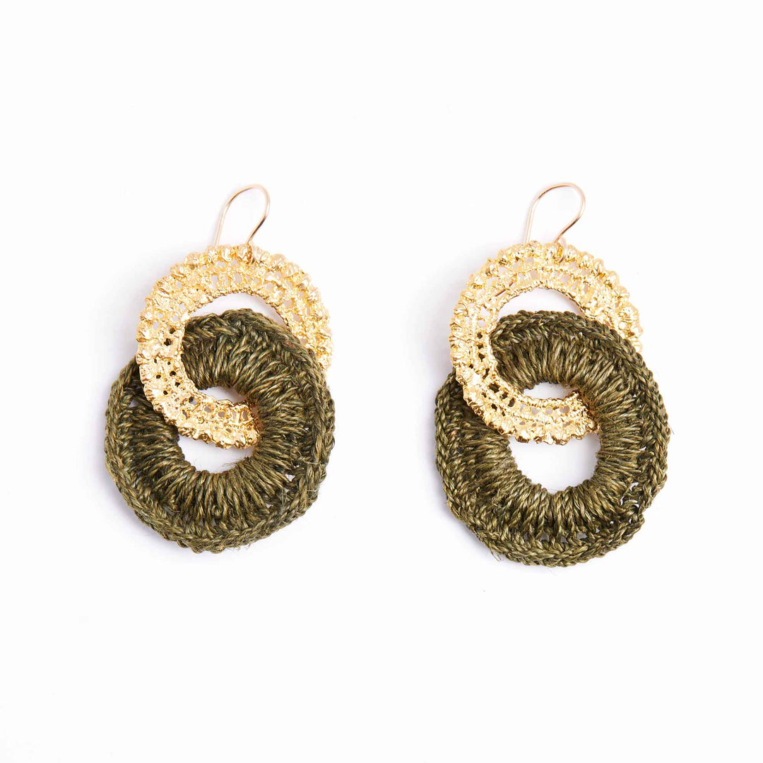 Pair of earrings with gold and green circular designs on a white background