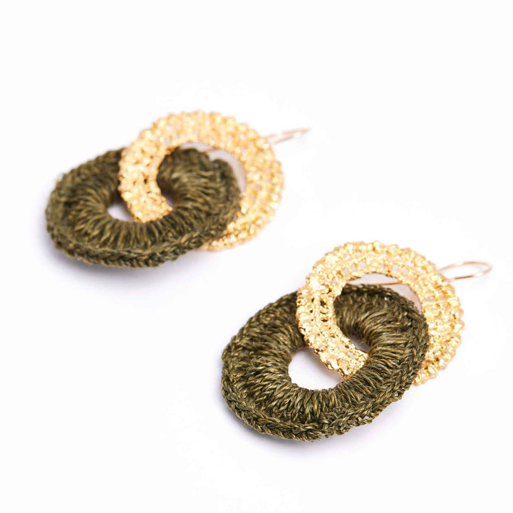Pair of gold and green hoop earrings on a white background