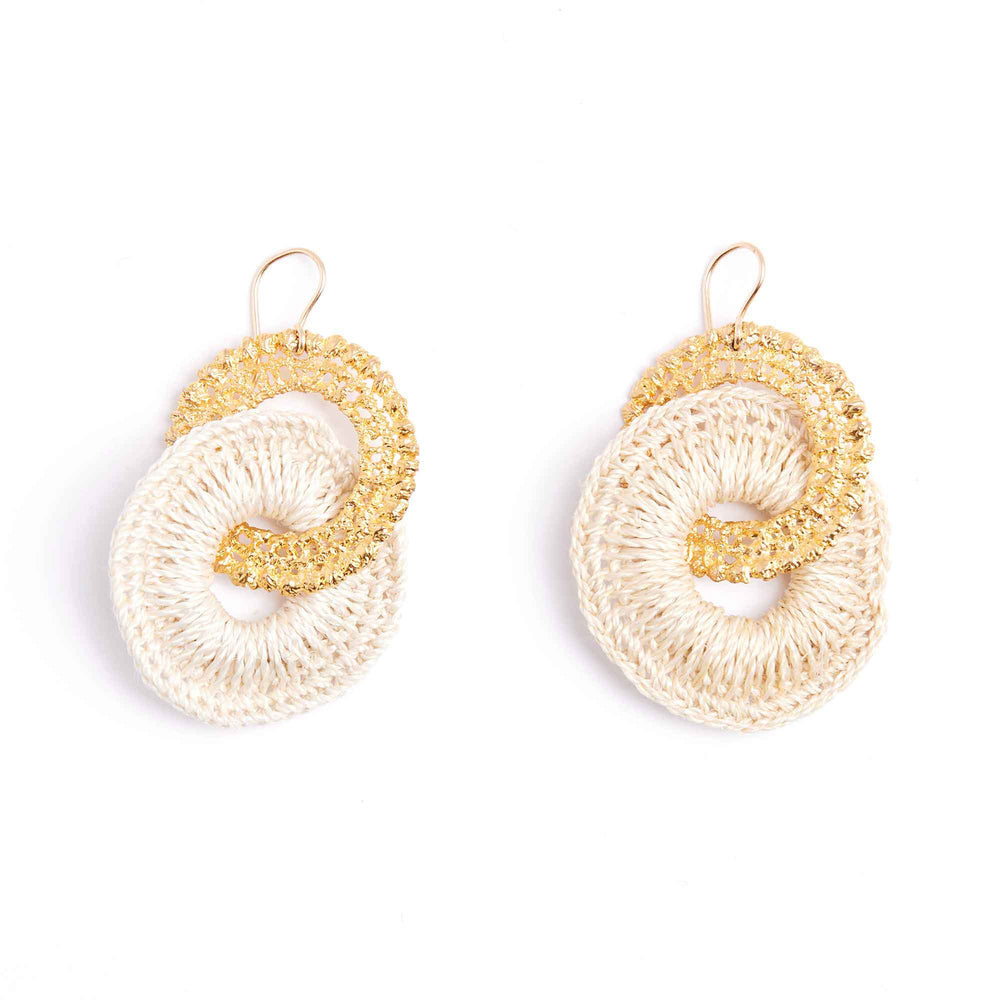 Pair of gold and beige crochet earrings on a white background