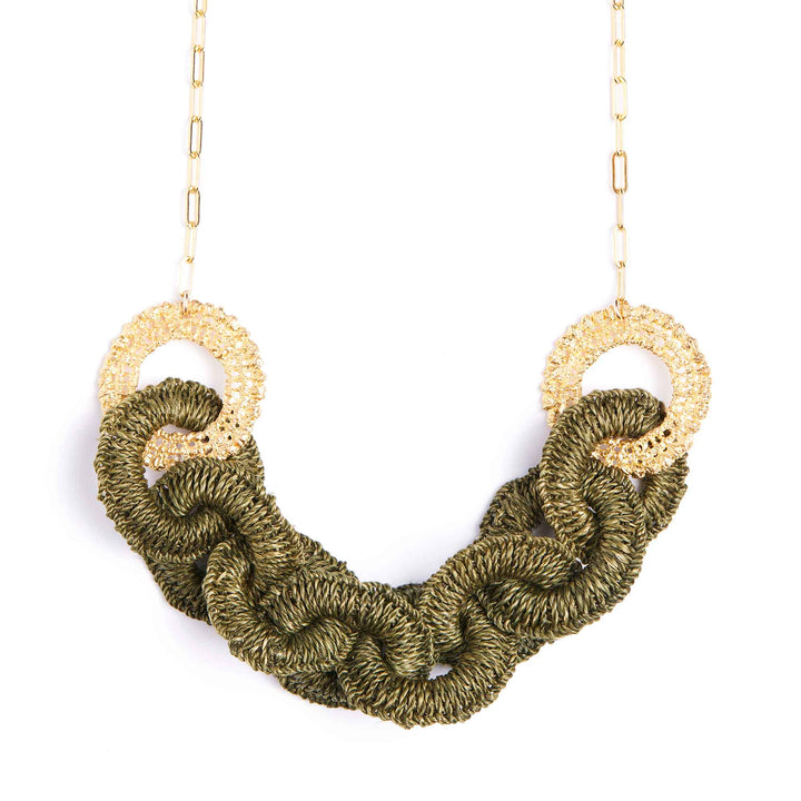 Necklace with gold rings and green braided design on a white background