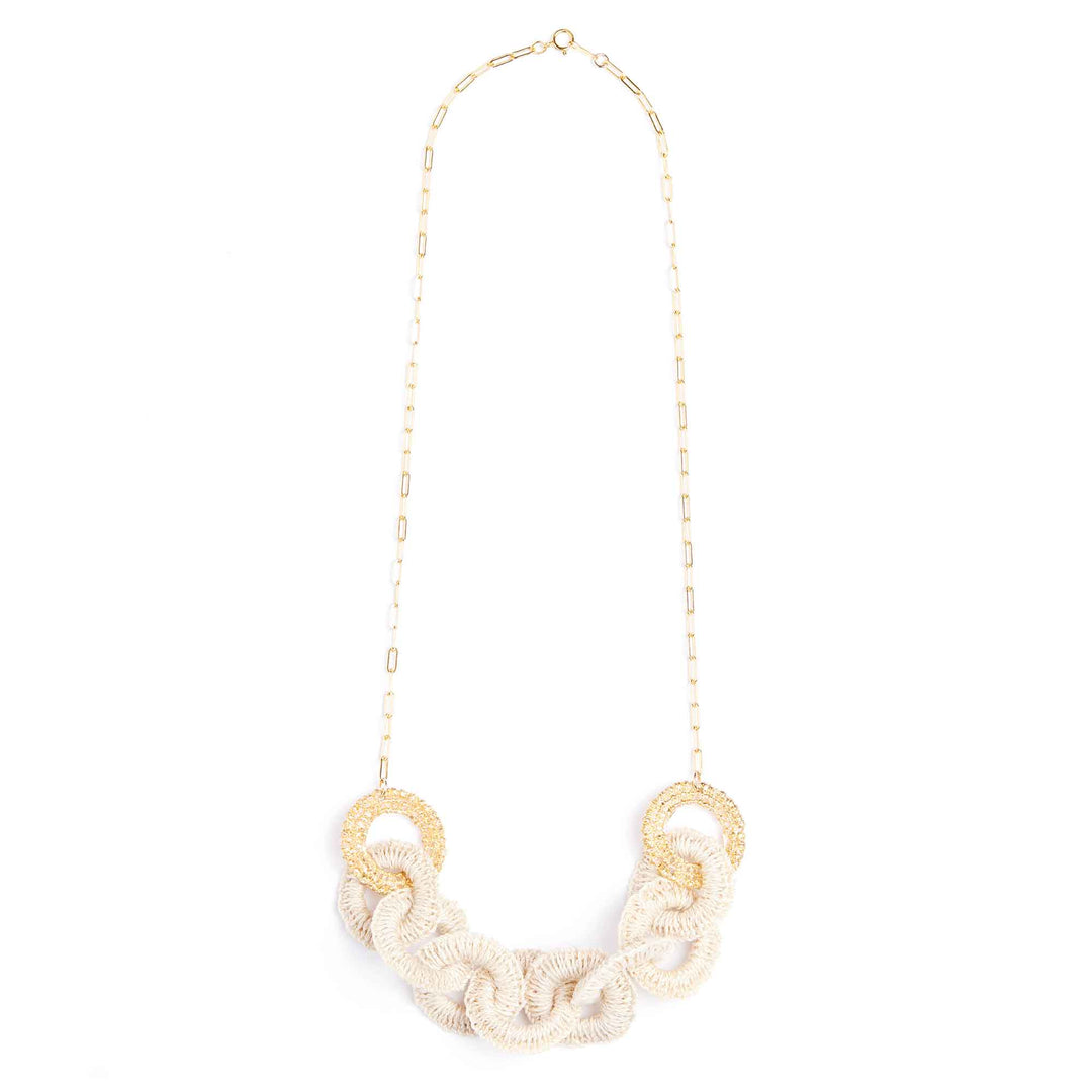 Necklace with gold rings and beige rope-like design on a white background
