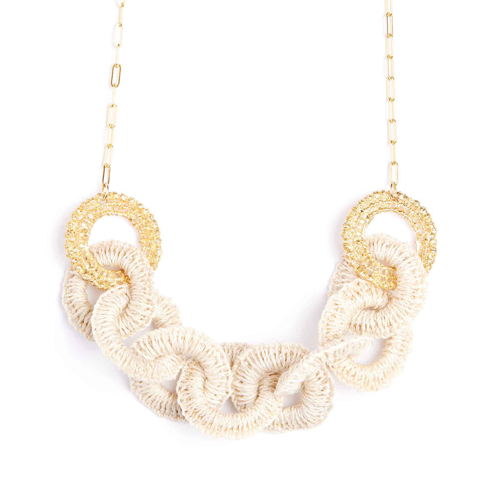 Necklace with gold and beige circular links on a white background