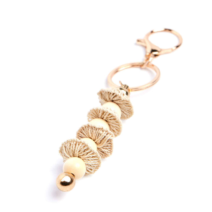 Gold tassel keychain on a white background