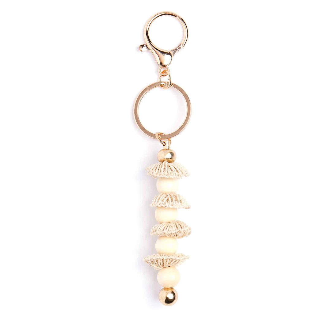 Gold keychain with decorative elements on a white background