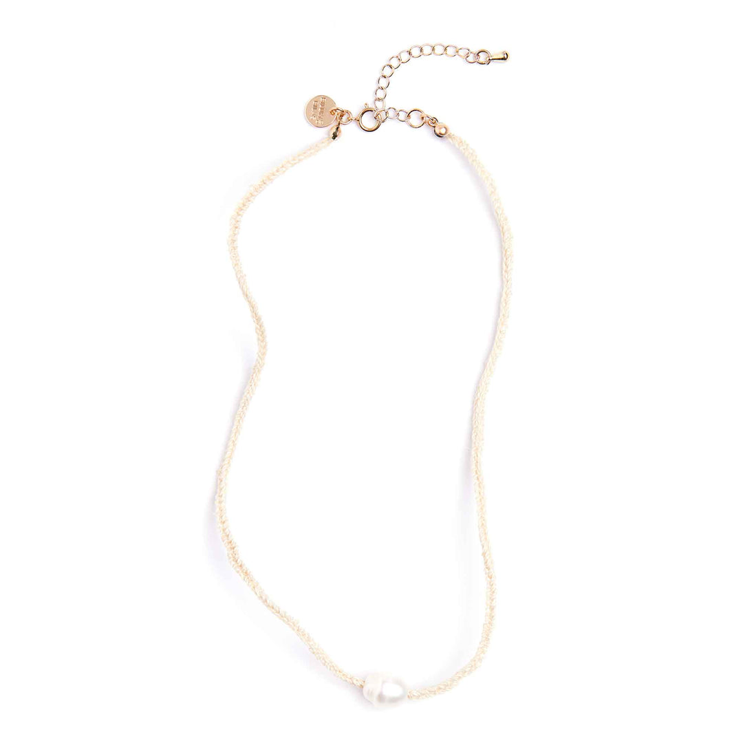 Gold necklace with a small pendant on a white background