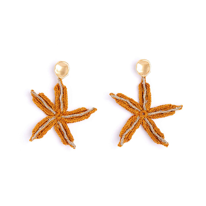 Starfish-shaped earrings with gold accents on a white background