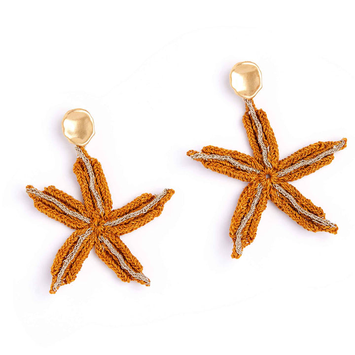 Star-shaped earrings with gold accents on a white background