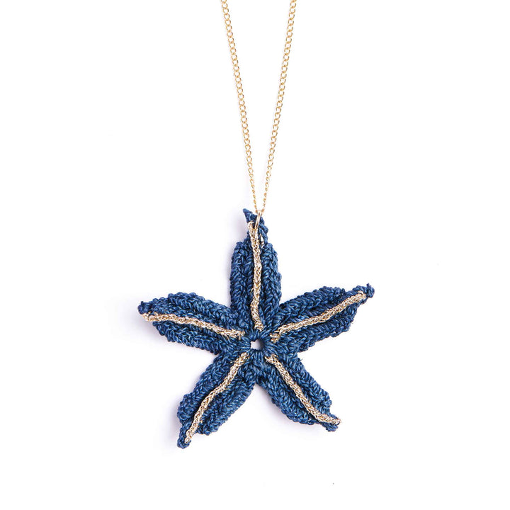 Blue starfish pendant on a gold chain against a white background