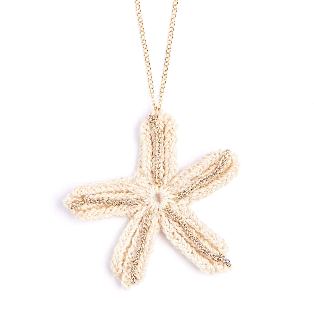 Gold starfish pendant necklace on a white background