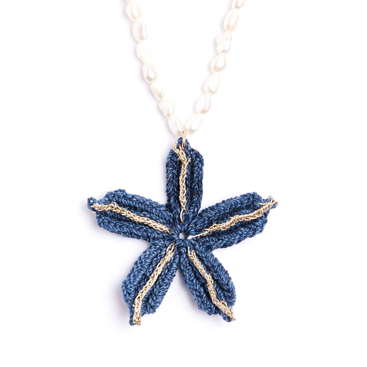 Blue star-shaped pendant on a white chain against a white background