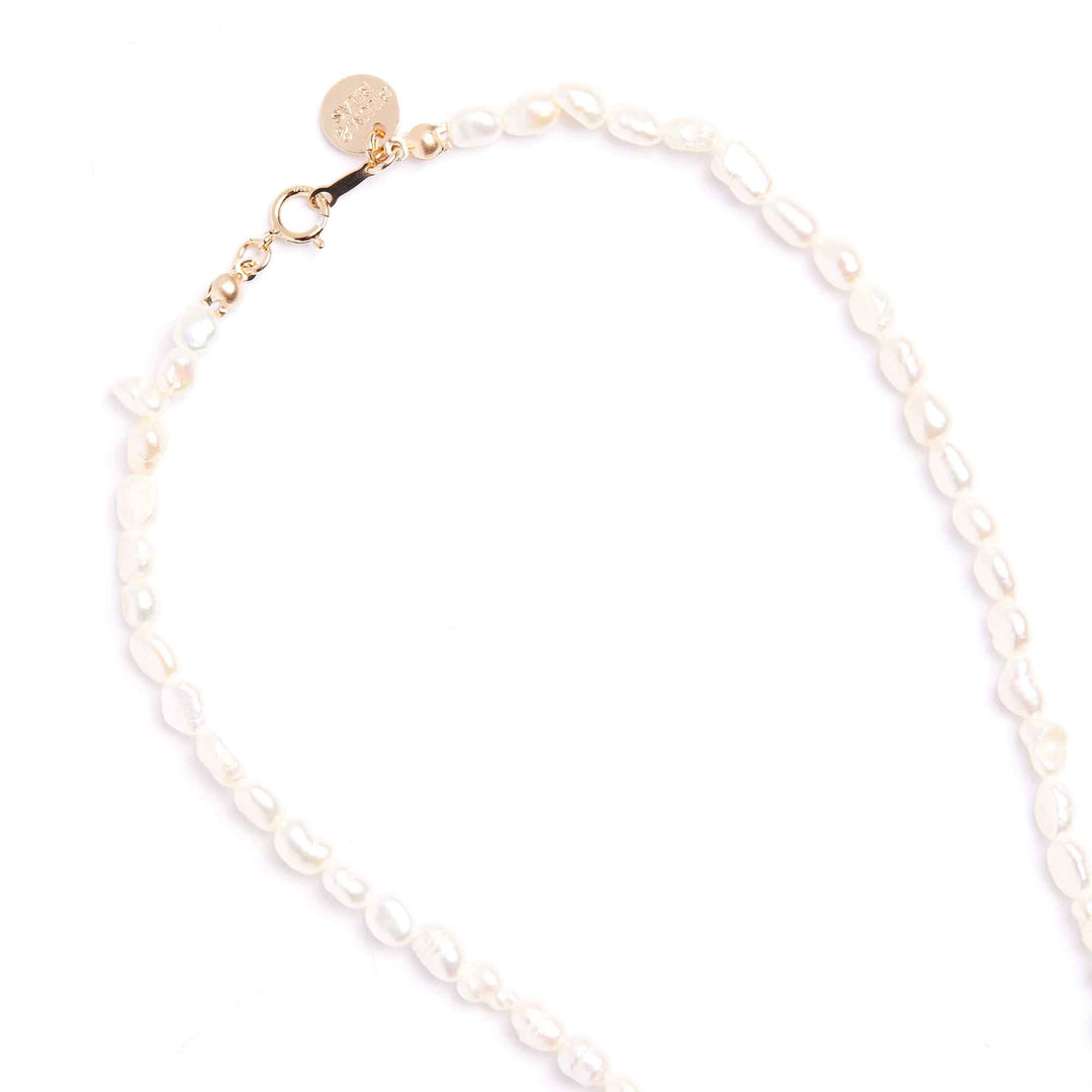 Pearl bracelet with gold clasp on a white background