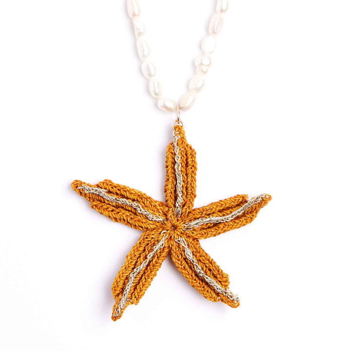 Knitted starfish pendant on a white background