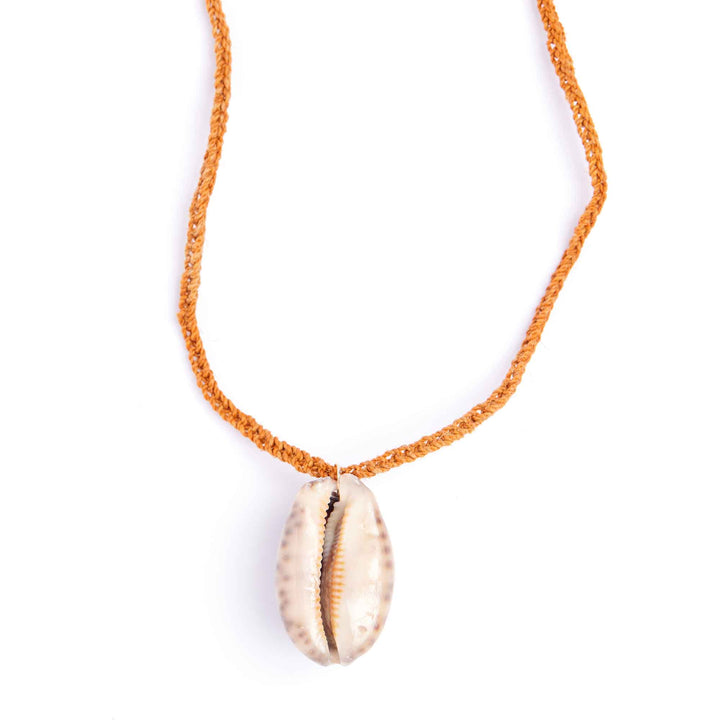 Necklace with a shell pendant on an orange cord against a white background