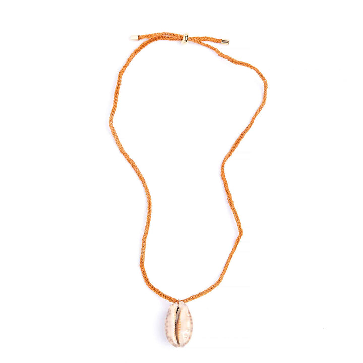 Necklace with a shell pendant on an orange cord against a white background