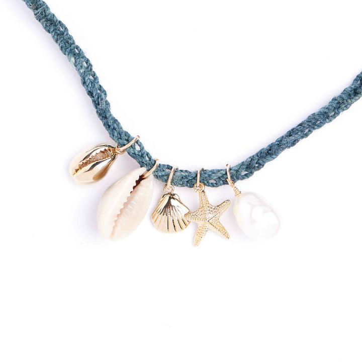 Necklace with gold shell and starfish charms on a white background