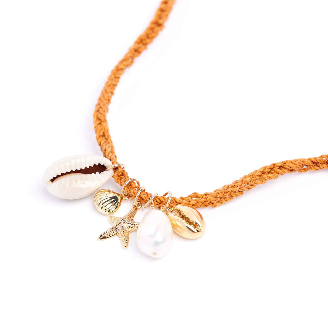 Bracelet with shell and starfish charms on a white background