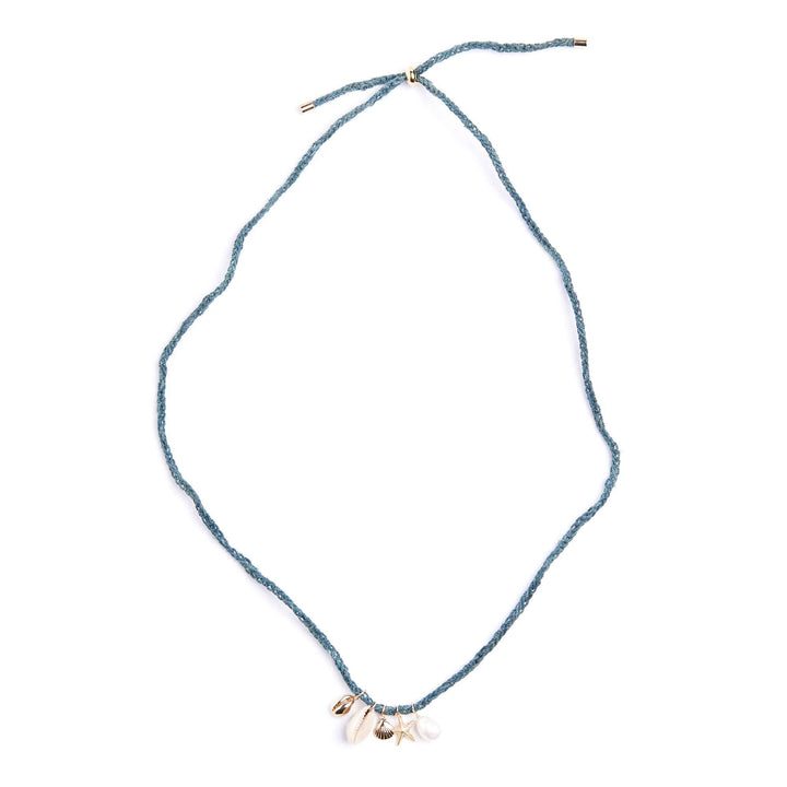 Blue string necklace with small charms on a white background