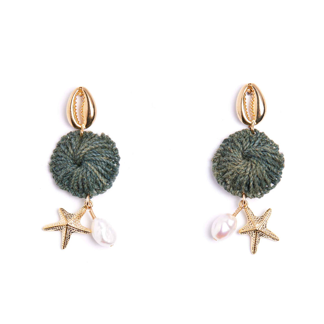 Pair of earrings with green knotted charms, starfish, and pearls on a white background