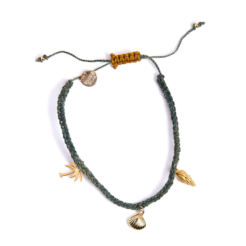 Green braided bracelet with gold charms on a white background
