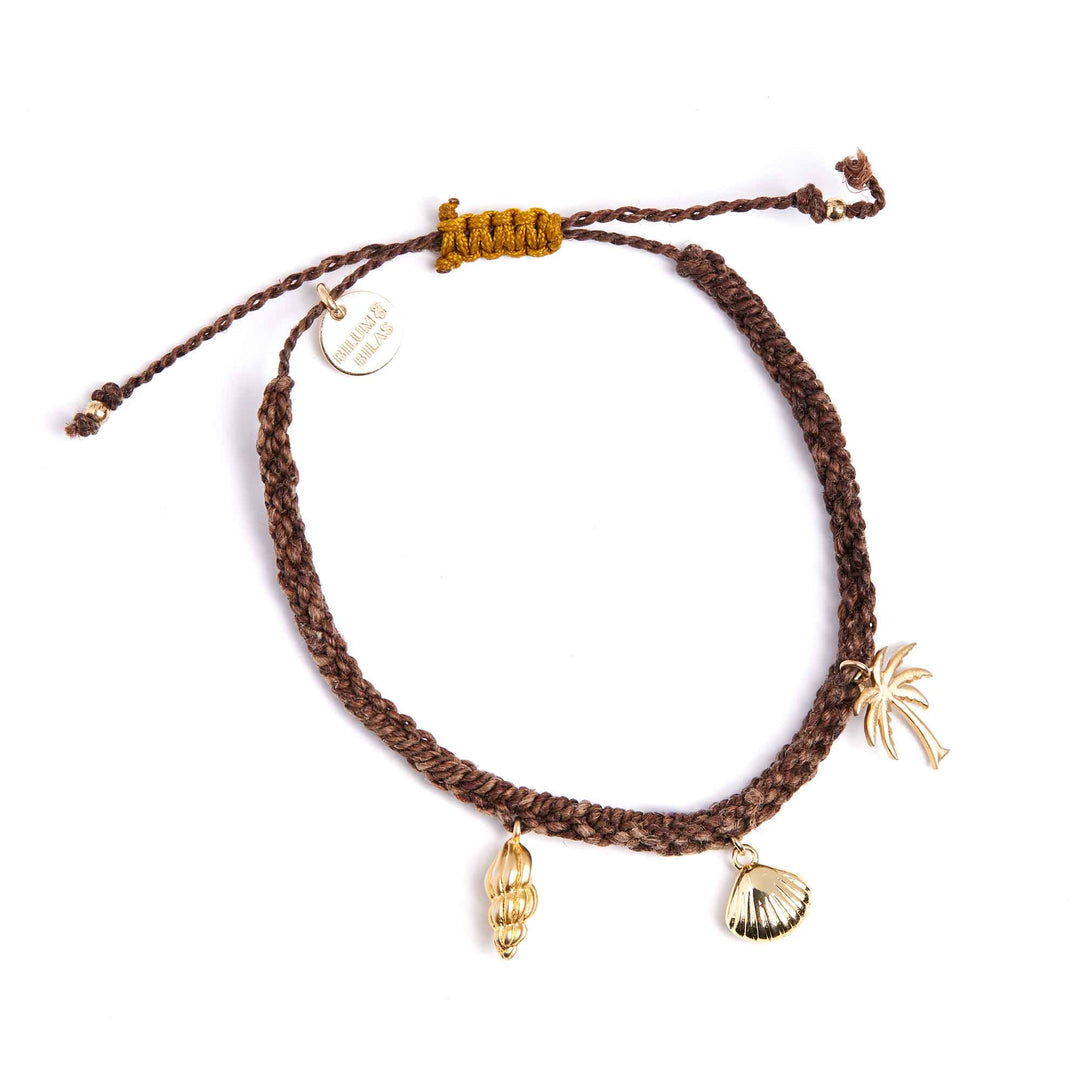Brown braided bracelet with gold charms on a white background