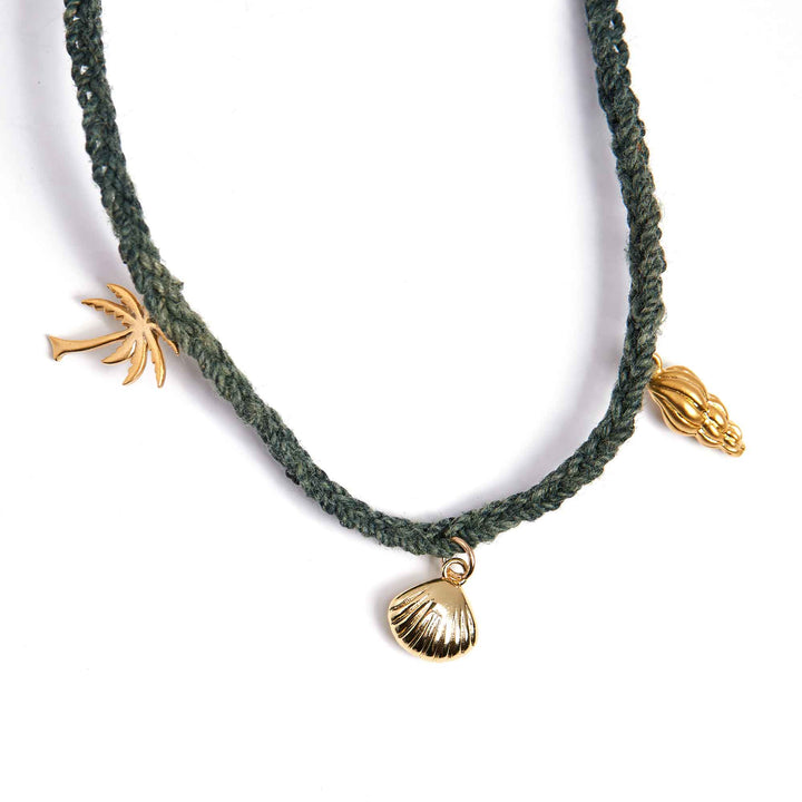 Necklace with gold shell and palm tree charms on a white background