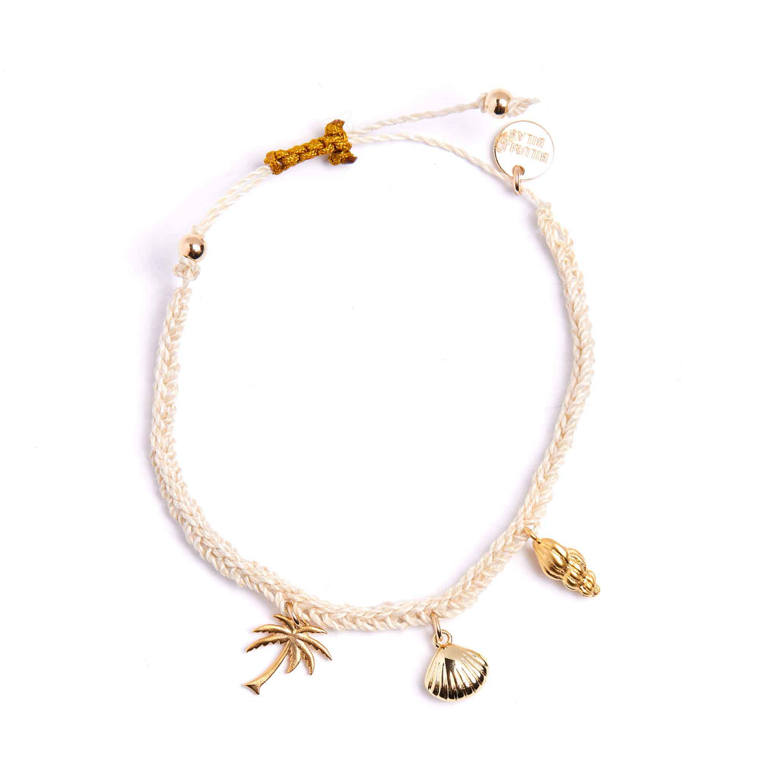 Bracelet with palm tree and shell charms on a white background