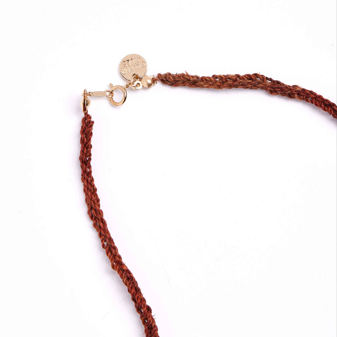 Brown braided necklace with a gold clasp on a white background