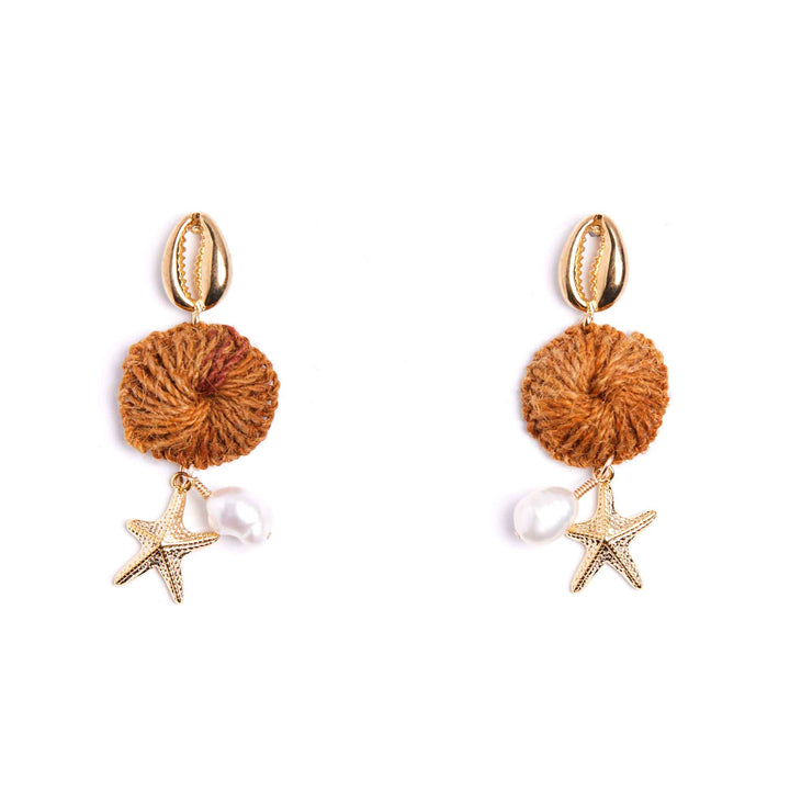 Pair of earrings with brown spherical elements, starfish, and pearls on a white background
