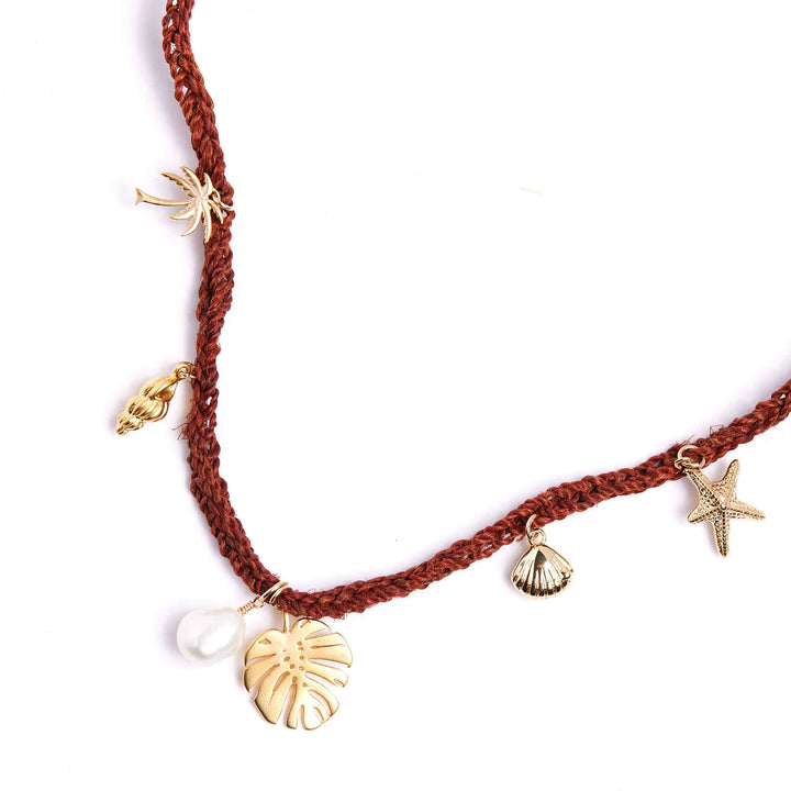 Brown braided necklace with gold charms on a white background