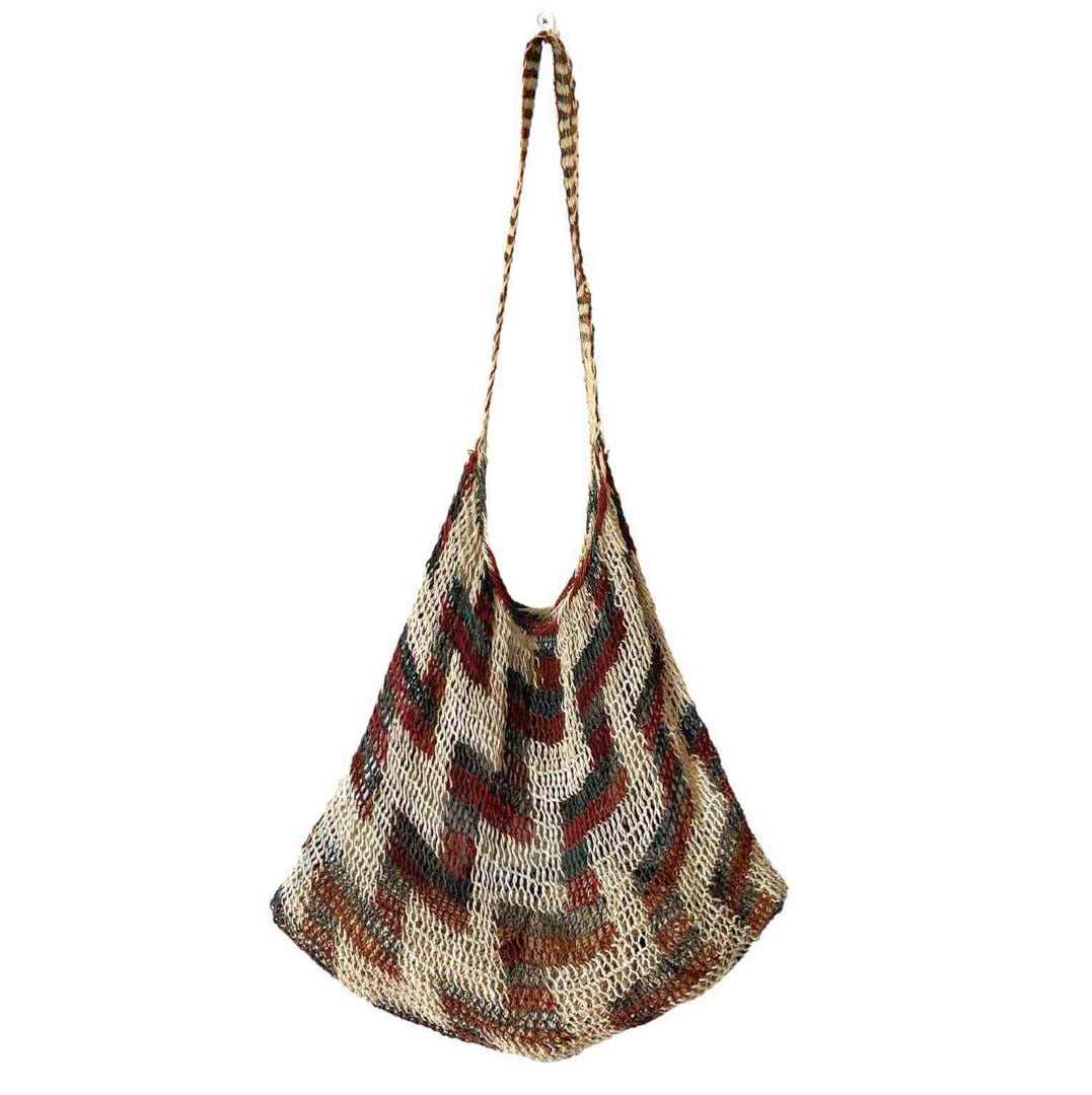 Traditional brown tone string bilum bag from Moment Village in Papua New Guinea hanging.