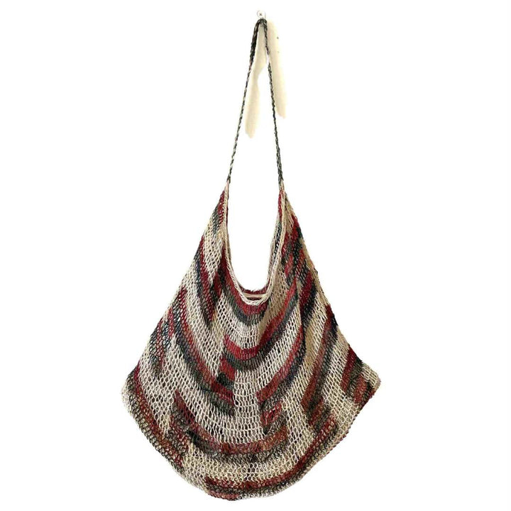Traditional brown and green tone string bilum bag from Moment Village in Papua New Guinea hanging.