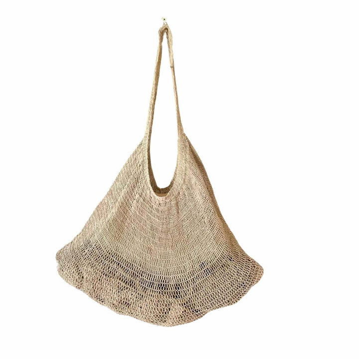 Plain natural fibre bilum hanging on white background.