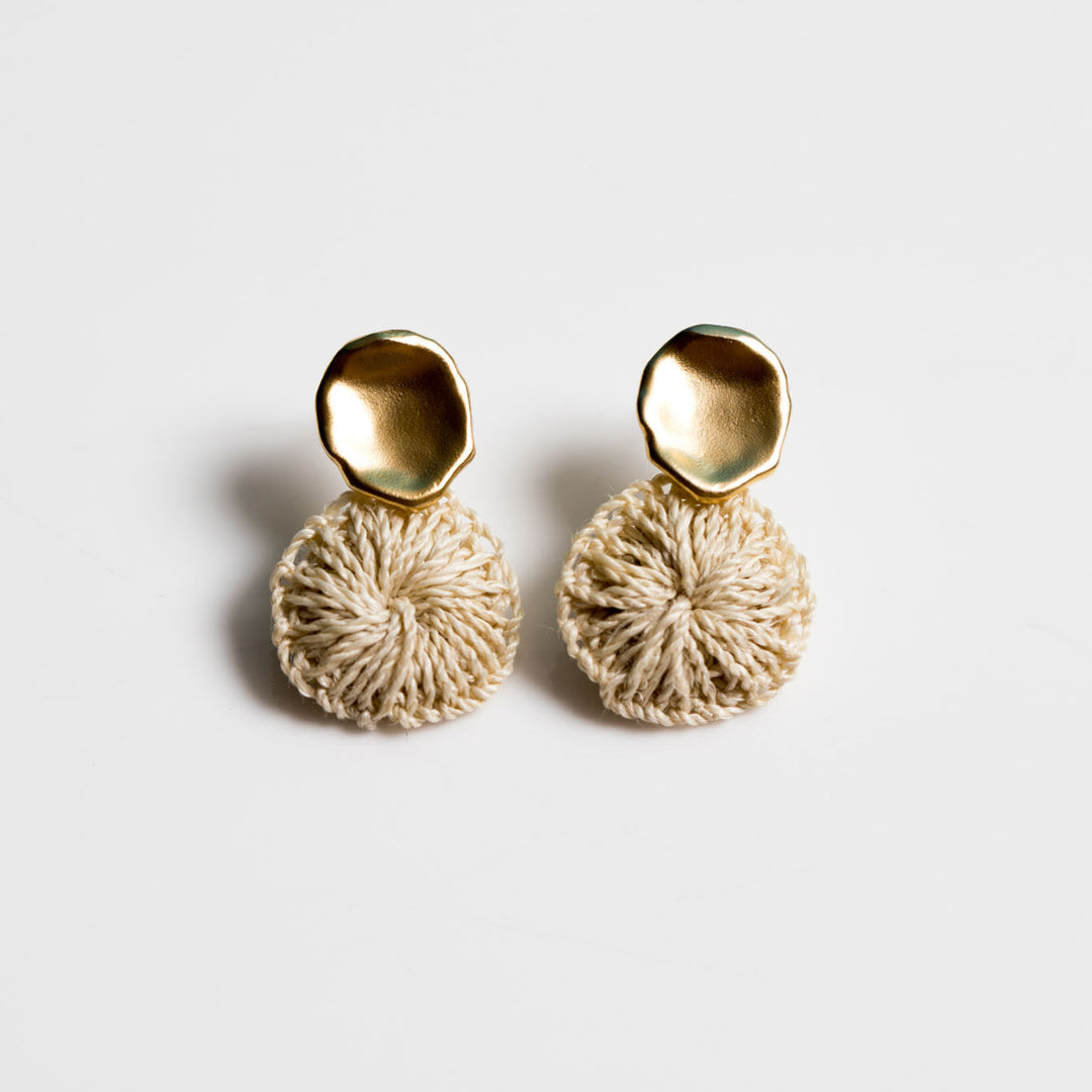 Bilum and Bilas warped gold stud earring with a dangling handwoven natural fibre disc 