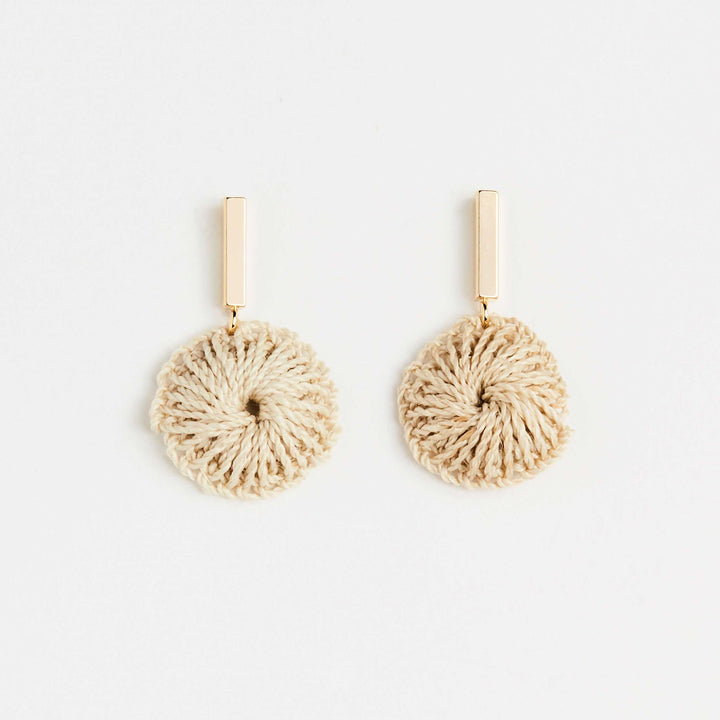 Bilum and Bilas gold bar earring with dangling handwoven natural fibre disc front view