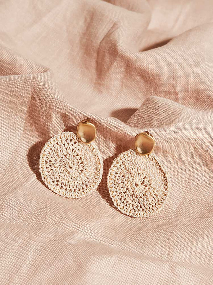 Bilum and Bilas Sowana disc earrings - Crochet woven disc earrings with gold ear post on pink linen