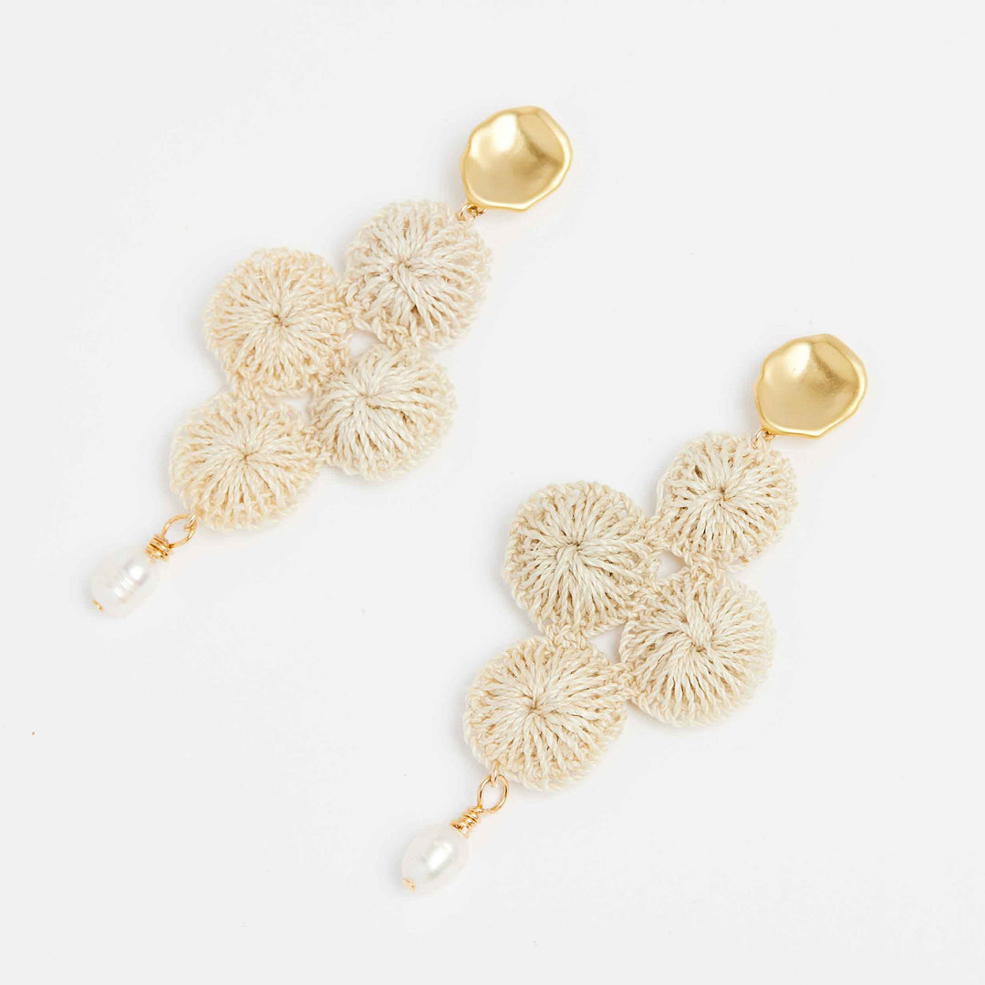 Gold Malalo Breeze earrings with pearl and natural fibre angle view