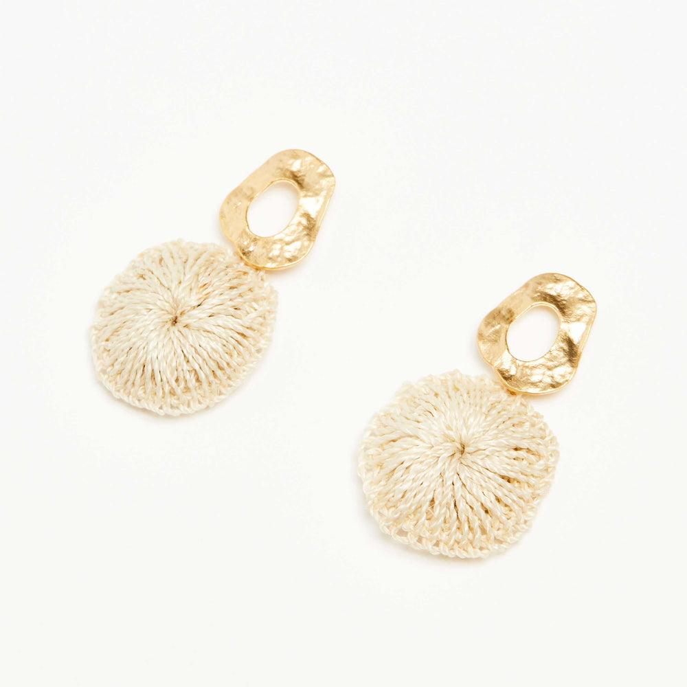 Bilum and Bilas Warp earring with textured gold circle earring and dangling natural fibre disc side view