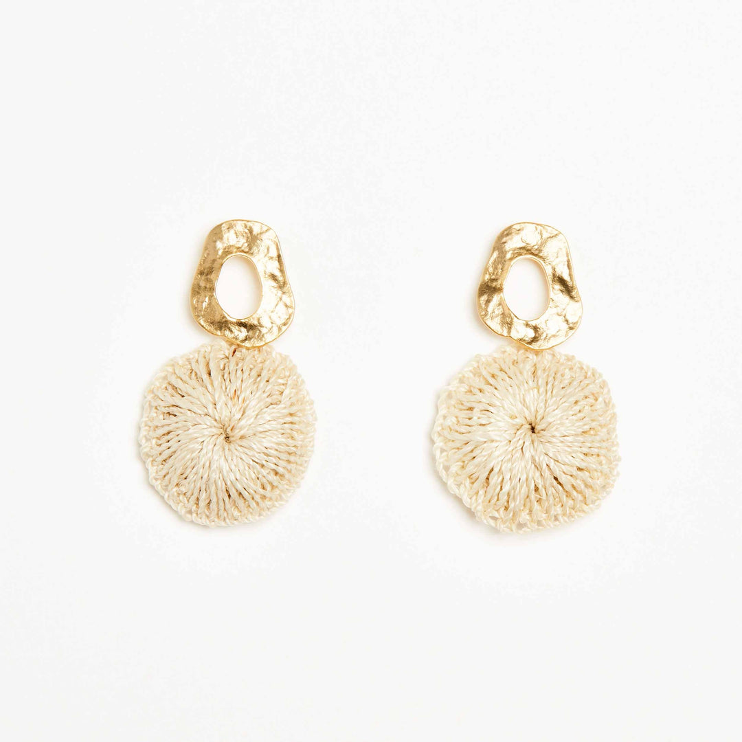 Bilum and Bilas Warp earring with textured gold circle earring and dangling natural fibre disc front view