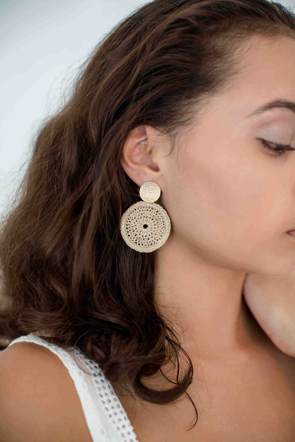 model wearing Bilum and Bilas boho chic natural fibre and gold disc earrings with metal ear post 
