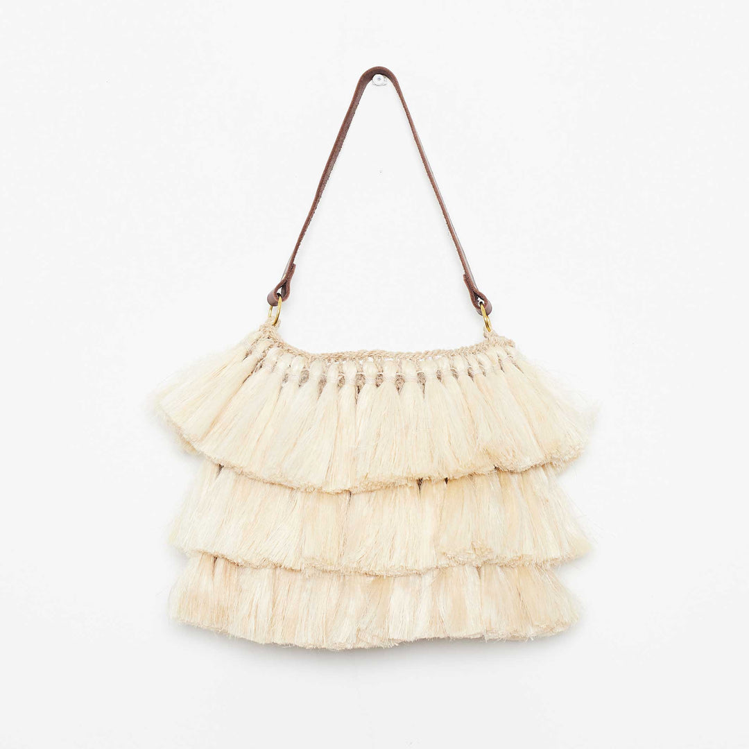 Three-tiered fringed handwoven bag on white background