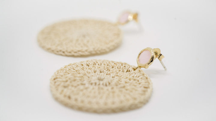 Close up view of Bilum and Bilas crochet style Kala earrings with pink stone ear post