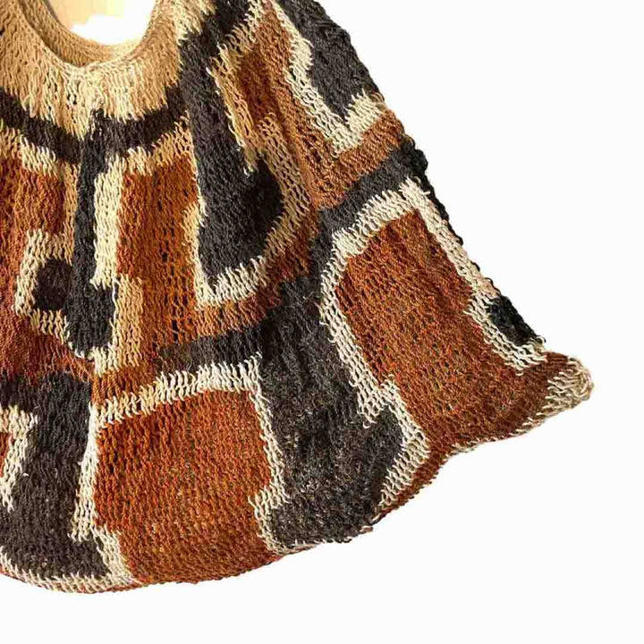 Corner of black, rust and white patterned string bilum from Kaminimbit Village in East Sepik Province.