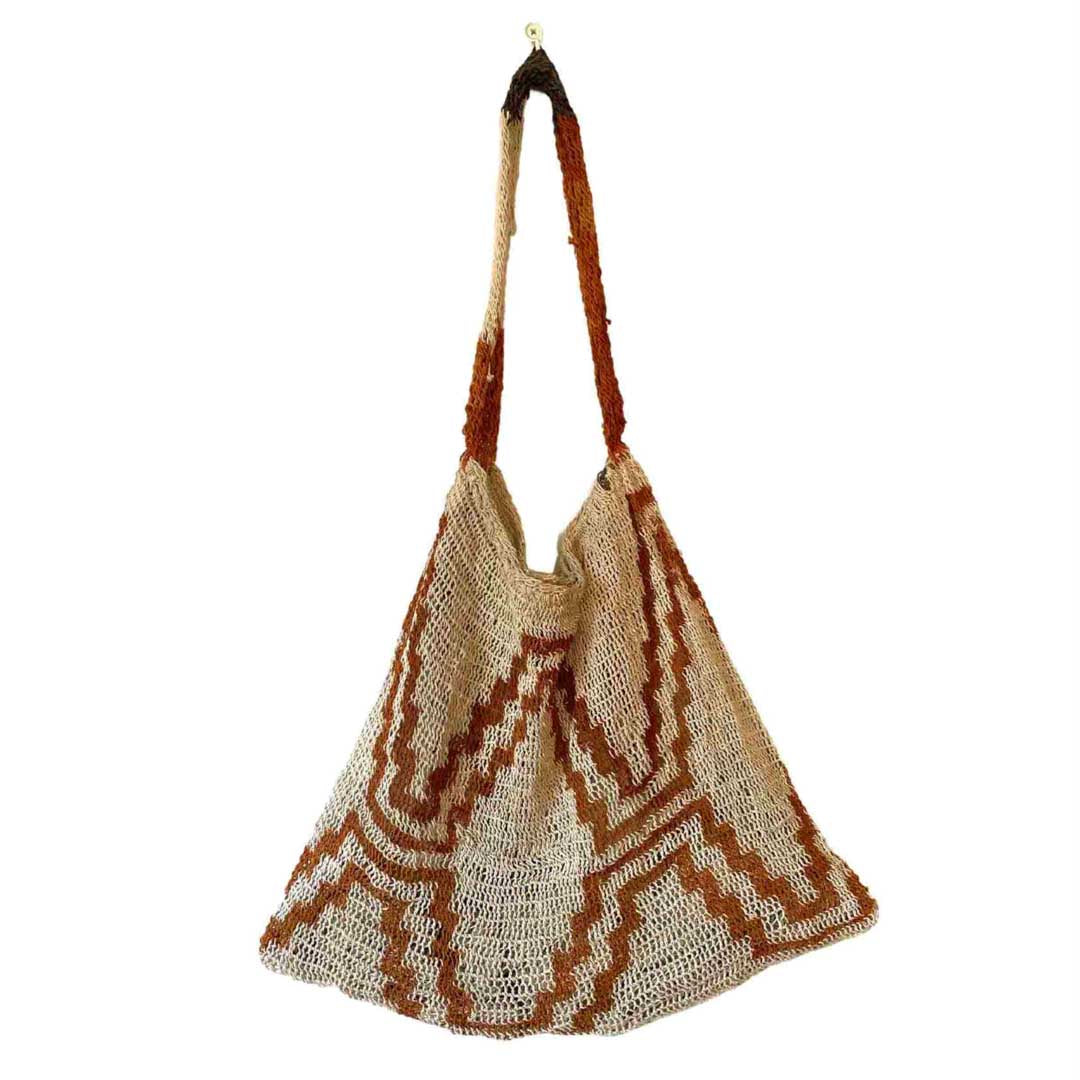 Orange and white string bilum from East Sepik Province displayed on a white background.