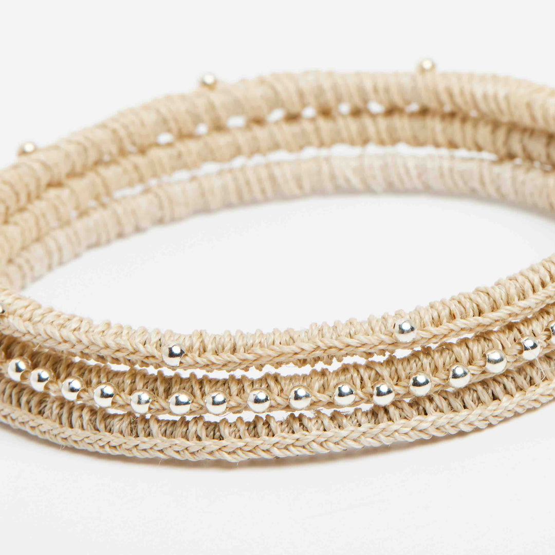 Angled close up on silver beaded Nambis luxury woven bangle set