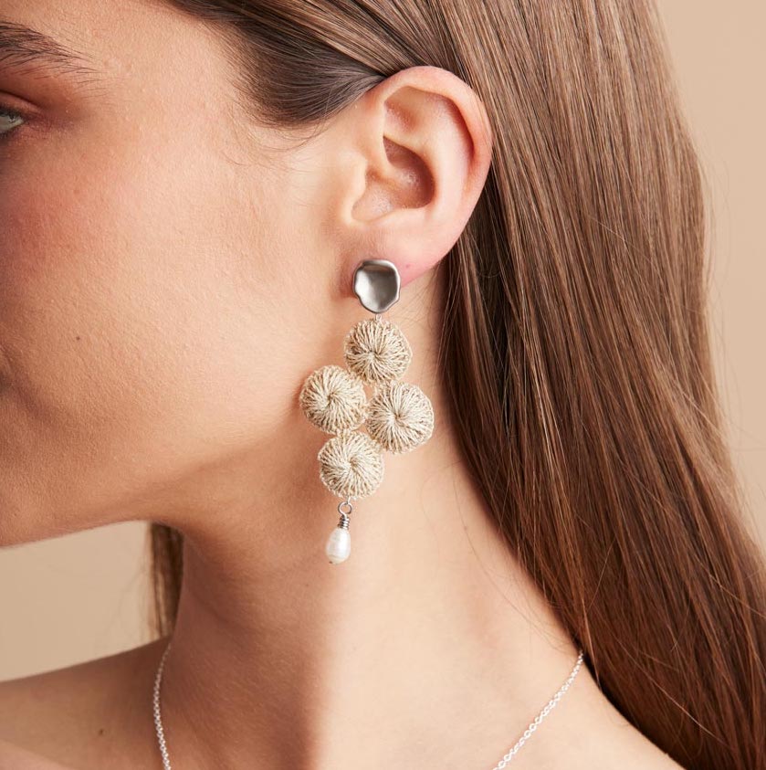 Silver Malalo Breeze earrings with pearl and natural fibre profile on model