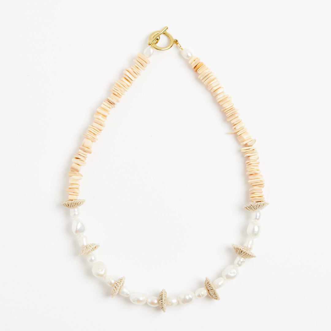 Front view of the pearl stack necklace with pearls and natural fibre woven discs
