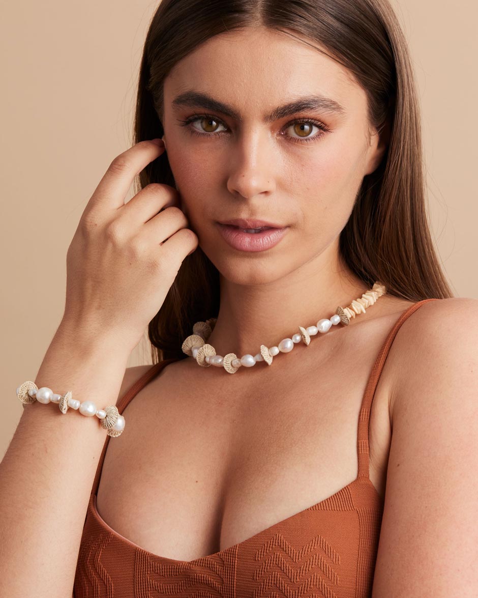 Model wearing pearl stack necklace and bracelet